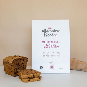 Gluten free Spiced bread mix in large pack. Loaf of Sliced Spiced bread in the front. Linen napkin in background