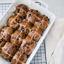 Load image into Gallery viewer, Gluten free hot cross buns in white dish on black rack. White linen background 